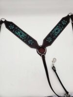 A leather horse breast collar adorned with intricate turquoise embroidery in a leafy pattern. The collar has metal rings and clasps for attachment and black straps extending from it, set against a plain white background.