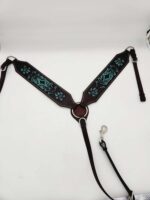 A leather horse breast collar with intricate turquoise embroidery. The design features floral patterns on dark brown leather. The collar has metal rings and clips for attachment and is photographed on a plain white background.