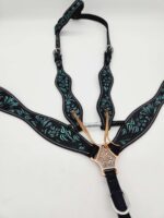 A black leather horse bridle with intricate turquoise floral patterns. It has silver hardware, adjustable straps, and a decorative metallic centerpiece. The bridle is arranged neatly on a white background.