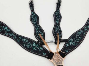 A black leather horse bridle with intricate turquoise floral patterns. It has silver hardware, adjustable straps, and a decorative metallic centerpiece. The bridle is arranged neatly on a white background.