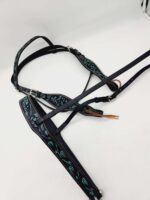 A black leather horse bridle with intricate turquoise stitching details is shown against a plain white background. The bridle features multiple straps and adjustable buckles.