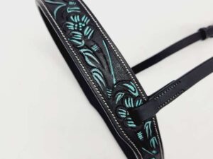 A black leather strap with intricate embossed floral designs in teal and green accents. The strap has stitching along the edges and a buckle for adjustment. The background is plain white.