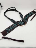 A brown leather breast collar for a horse is adorned with intricate turquoise embroidery. The piece includes adjustable straps and silver buckles, displayed against a white background. The design features swirling floral patterns for a decorative touch.