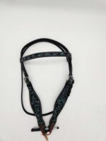 A black horse bridle is decorated with intricate teal embroidery patterns on the browband and noseband. The bridle is laid flat on a white background, and multiple adjustments and buckles are visible.