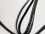 Close-up of multiple black leather straps with one strap featuring an intricate blue and green patterned design on a white background. The straps are slightly curved and overlapping.