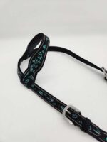 A black horse halter with blue and white decorative stitching on the straps, lying on a plain white background. The halter includes silver metal buckles for adjustment.