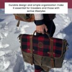 A person is holding a stylish, durable bag with a plaid design and leather straps. The snowy background suggests a cold weather or outdoor setting. The text above reads, "Durable design and ample organization make it essential for travelers and those with active lifestyles.