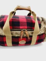 A stylish duffel bag featuring a red and black checkered pattern on the body, with tan canvas handles, zippers with leather pull tabs, and a small leather logo patch on one side. The bag sits on a plain white background.